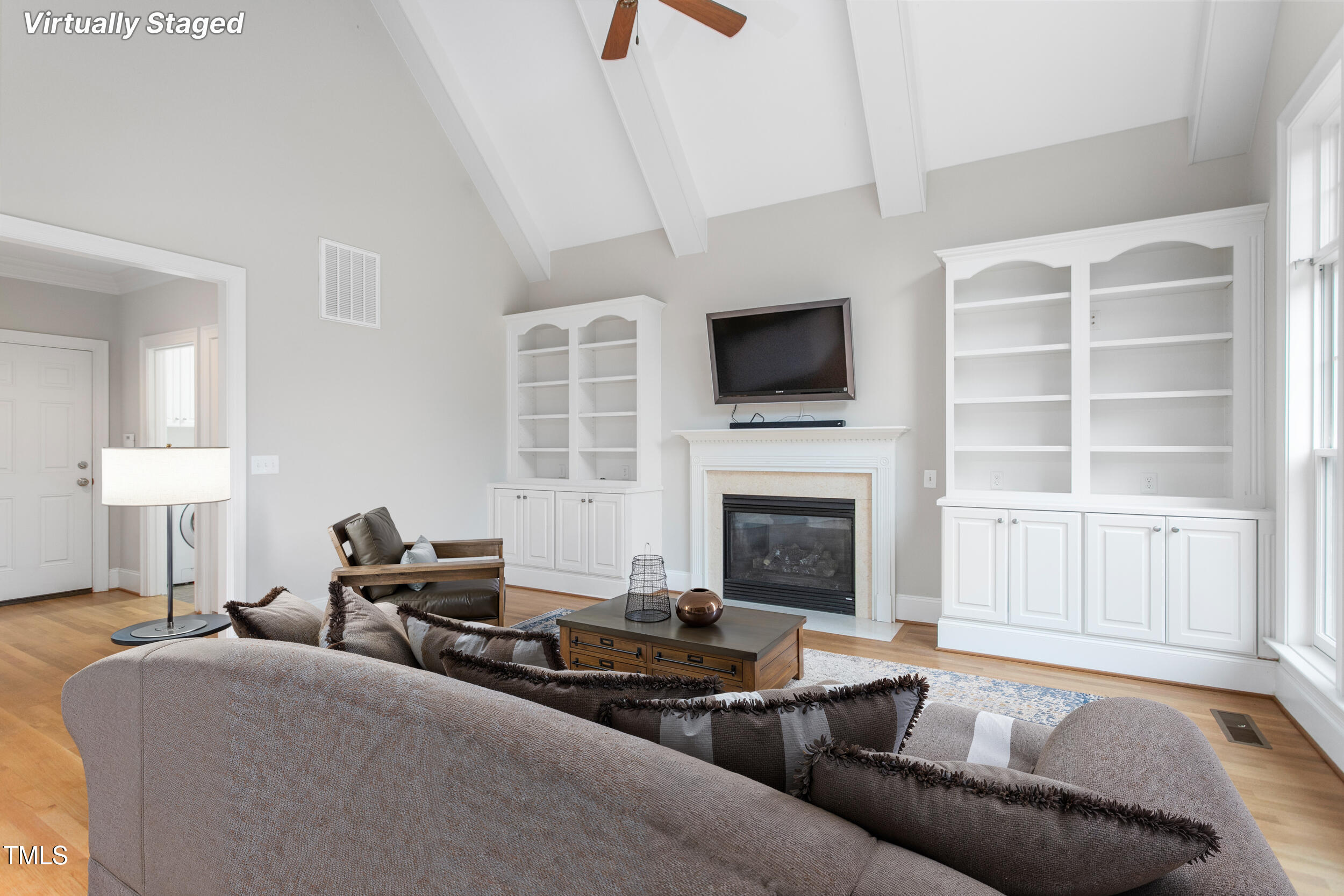 6366 Lineberry Road Liberty, NC 27298 - Photo 18 of 44 a living room with furniture a fireplace and a flat screen tv