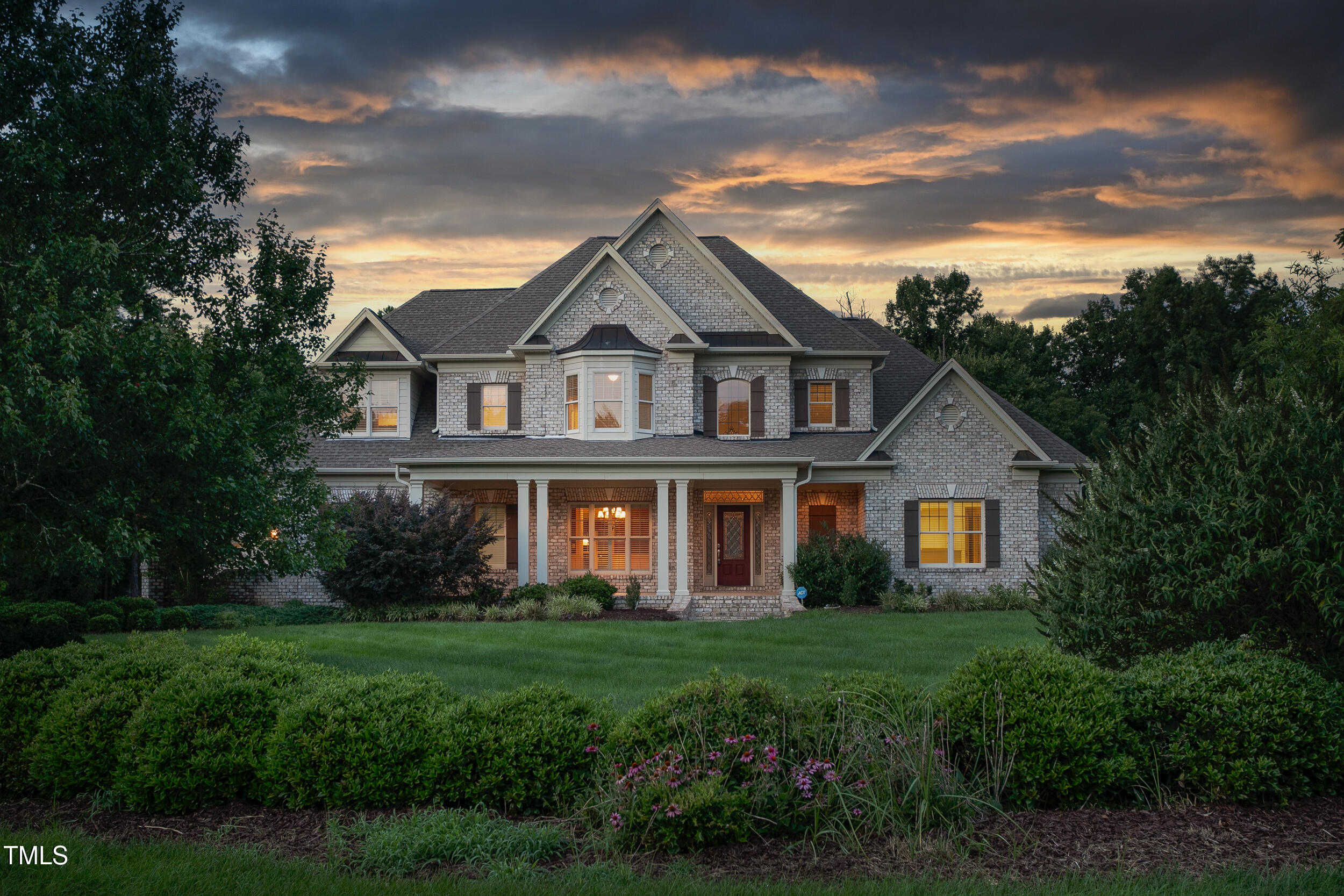 6366 Lineberry Road Liberty, NC 27298 - Photo 3 of 44 a front view of a house with a garden