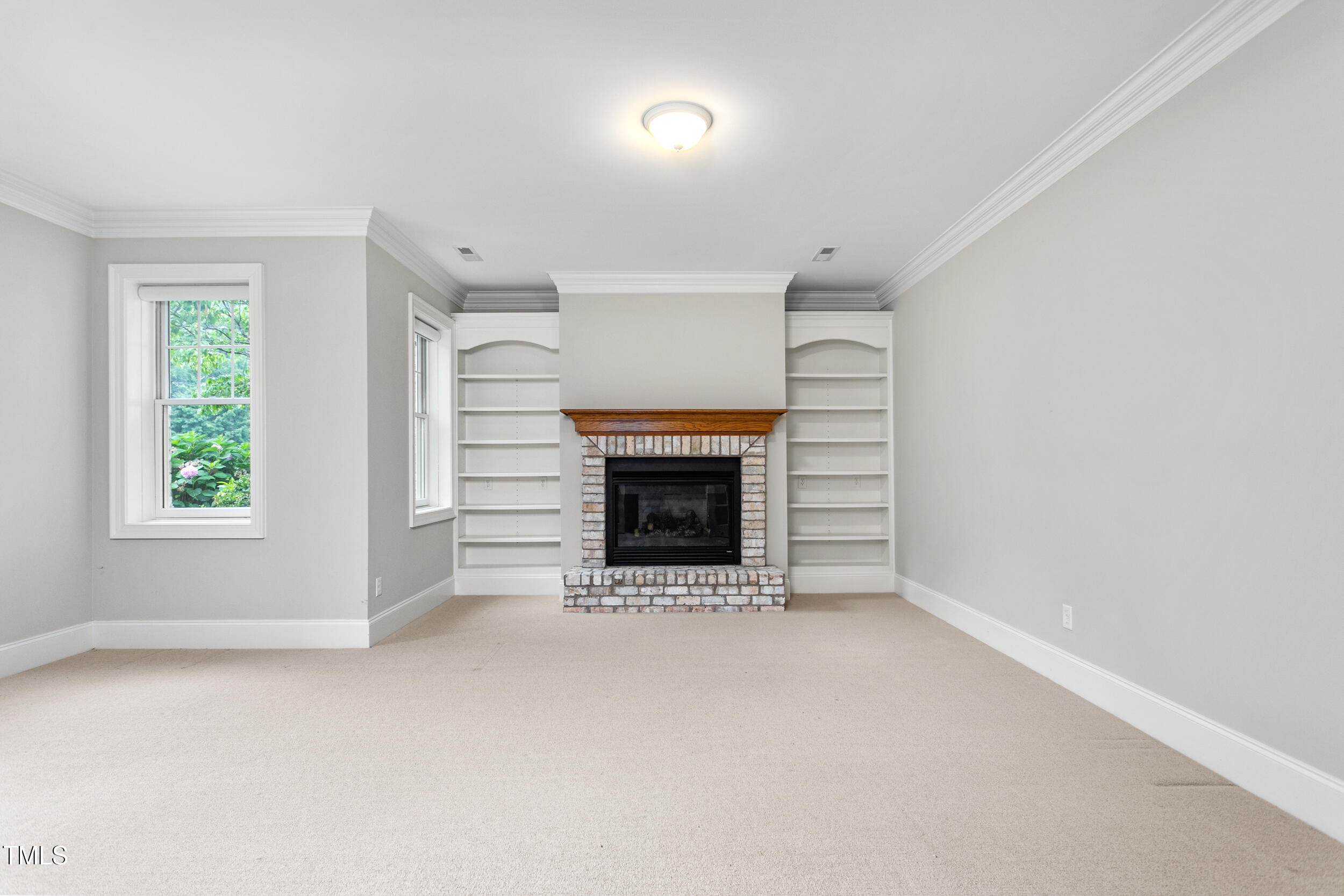 6366 Lineberry Road Liberty, NC 27298 - Photo 33 of 44 a view of an empty room with a fireplace and a window