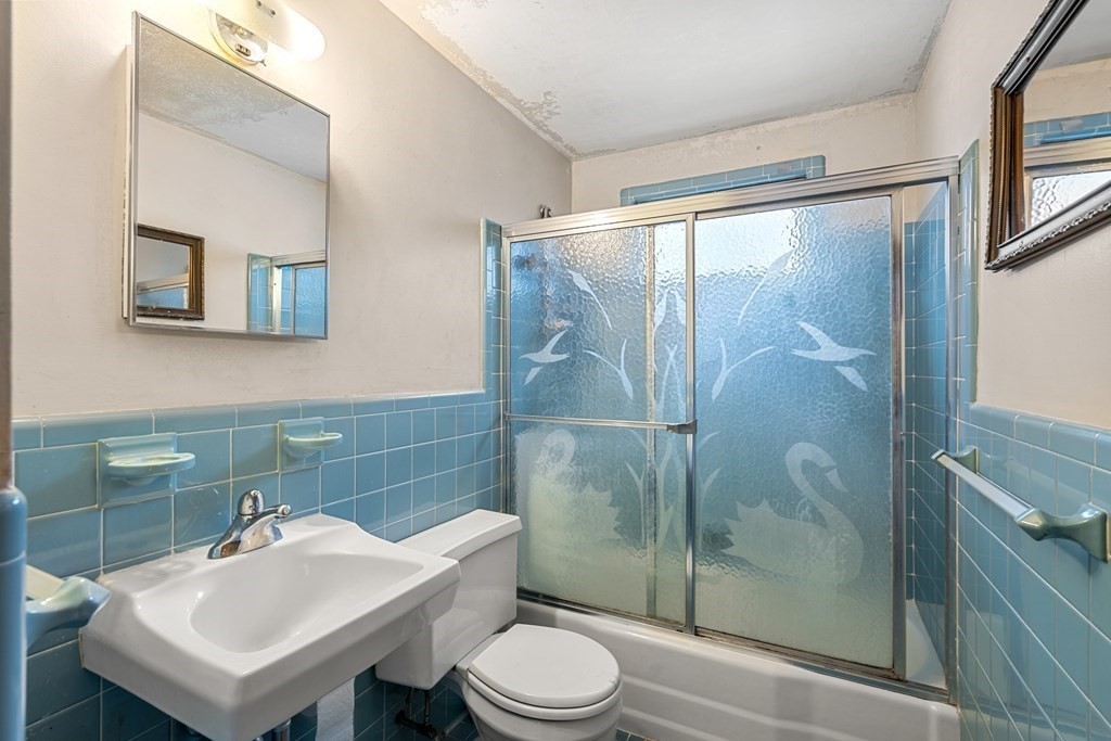 9-13 Sutherland Road Arlington, MA 02476 - Photo 15 of 20 a bathroom with a sink toilet and shower