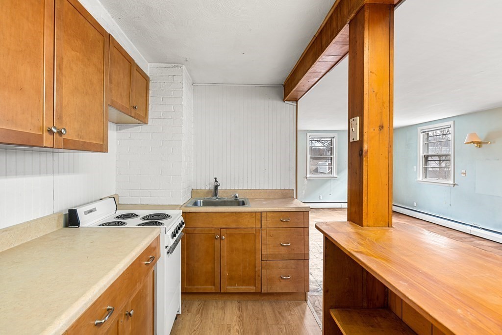 9-13 Sutherland Road Arlington, MA 02476 - Photo 16 of 20 a kitchen with a sink and cabinets