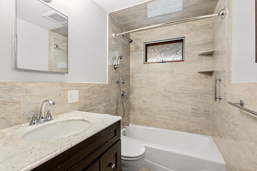 9-13 Sutherland Road Arlington, MA 02476 - Photo 6 of 20 a bathroom with a granite countertop sink a toilet and bathtub