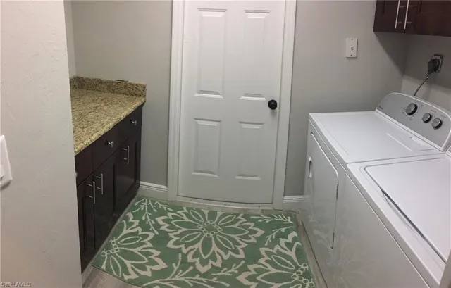 a utility room with a sink a washer and dryer