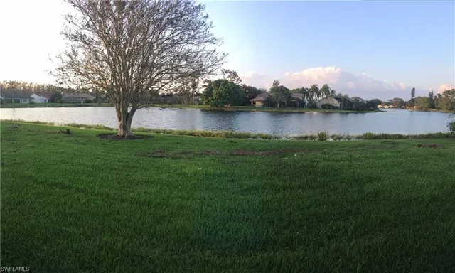 a view of a lake with houses in the back