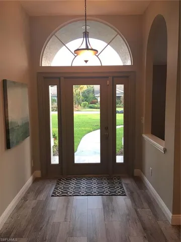 a view of entryway with a front door and wooden floor