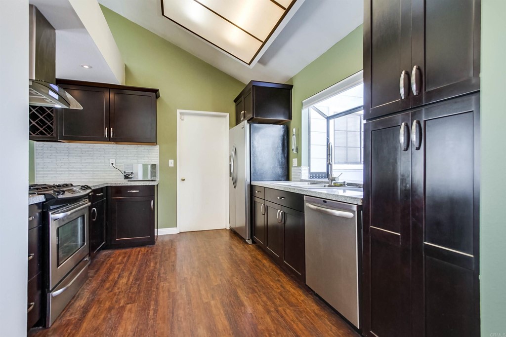 875 Viewpoint Drive San Marcos, CA 92078 - Photo 11 of 60 a kitchen with stainless steel appliances granite countertop a refrigerator a stove and a wooden floors