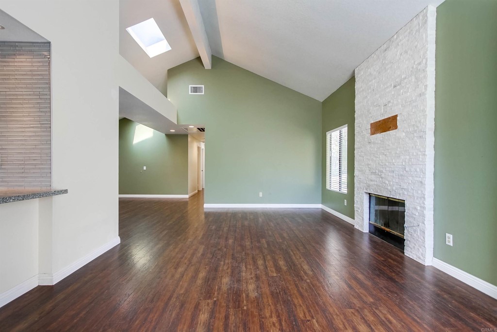 875 Viewpoint Drive San Marcos, CA 92078 - Photo 20 of 60 a view of a livingroom with wooden floor a fireplace and window