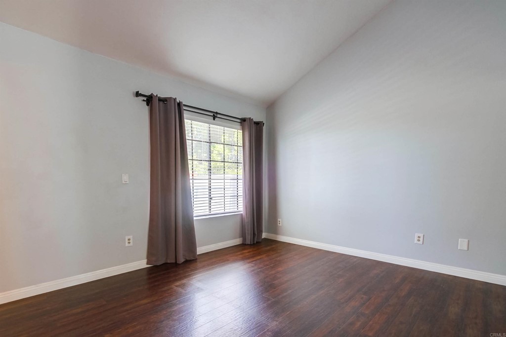 875 Viewpoint Drive San Marcos, CA 92078 - Photo 21 of 60 a view of an empty room with wooden floor and a window