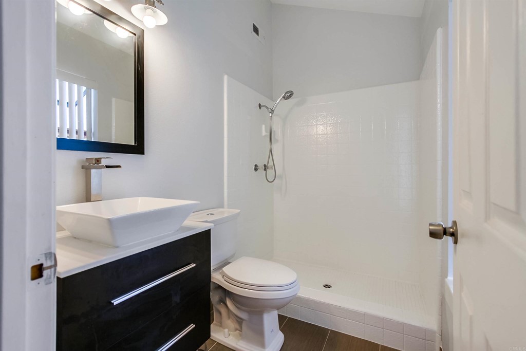 875 Viewpoint Drive San Marcos, CA 92078 - Photo 28 of 60 a bathroom with a sink a toilet a mirror and shower
