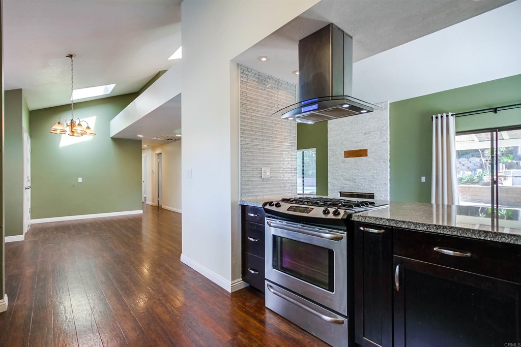 875 Viewpoint Drive San Marcos, CA 92078 - Photo 9 of 60 a kitchen with granite countertop a stove and a wooden floors