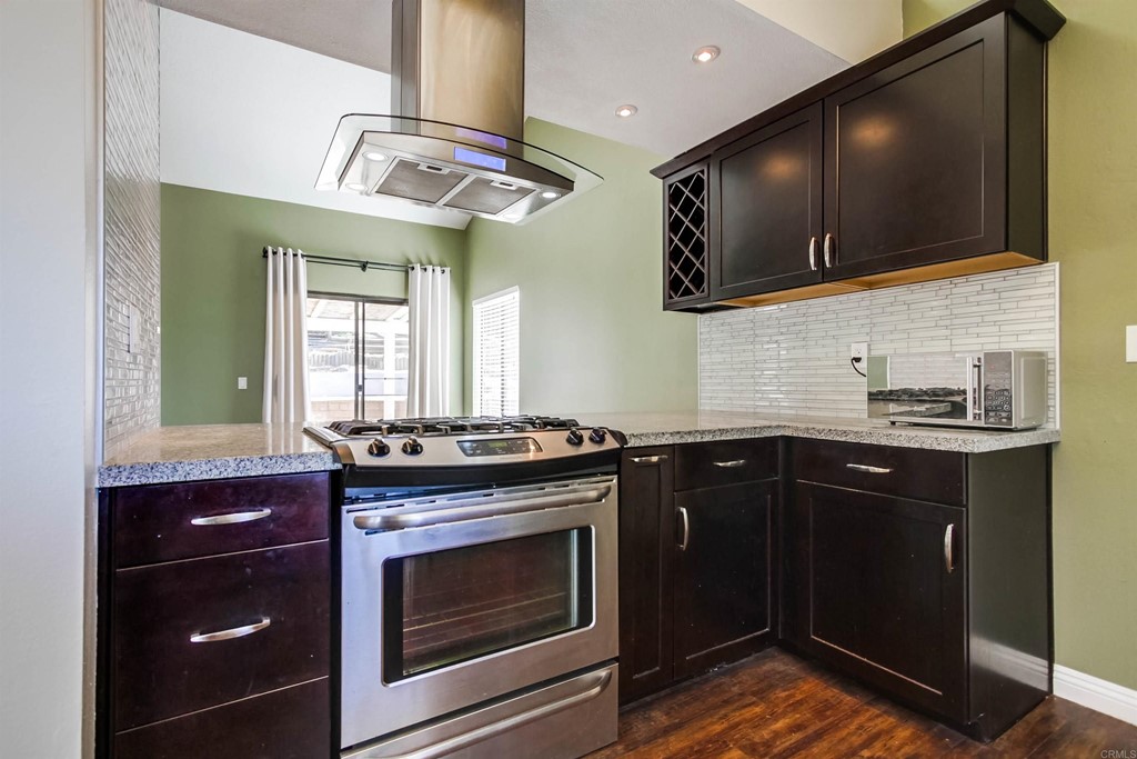 875 Viewpoint Drive San Marcos, CA 92078 - Photo 10 of 60 a kitchen with stainless steel appliances a stove and a microwave
