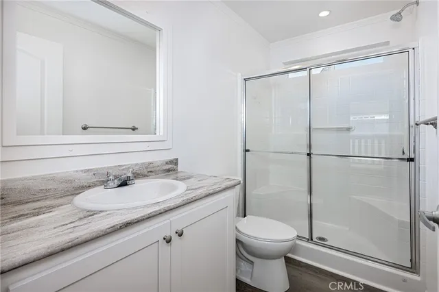 a bathroom with a granite countertop sink toilet and shower