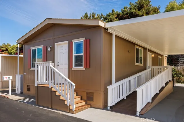 a view of a house with wooden fence