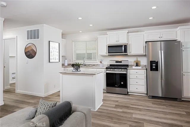 a kitchen with stainless steel appliances a refrigerator sink and stove