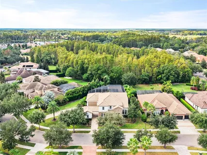 an aerial view of a house with yard swimming pool and outdoor seating