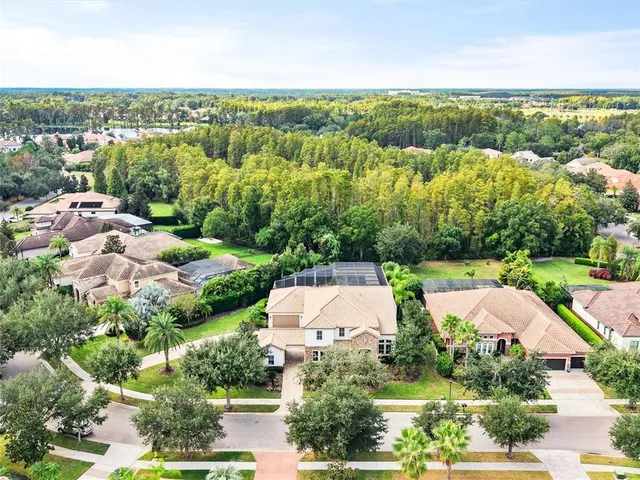 an aerial view of a house with yard swimming pool and outdoor seating