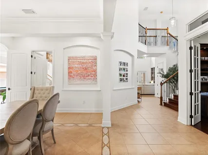 a view of a patio with a table and chairs under an umbrella