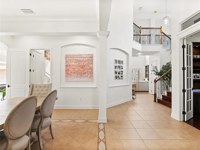 a view of a patio with a table and chairs under an umbrella