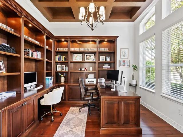 a kitchen with a dining table chairs stainless steel appliances and cabinets