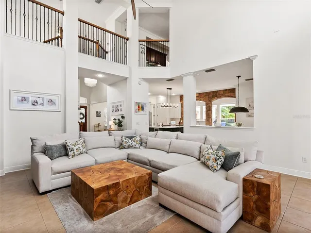 a living room with furniture a window and a potted plant