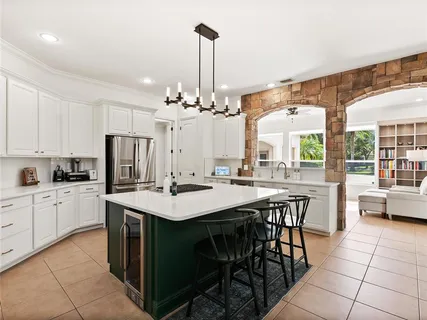 a bedroom with a bed and a large window with outer view
