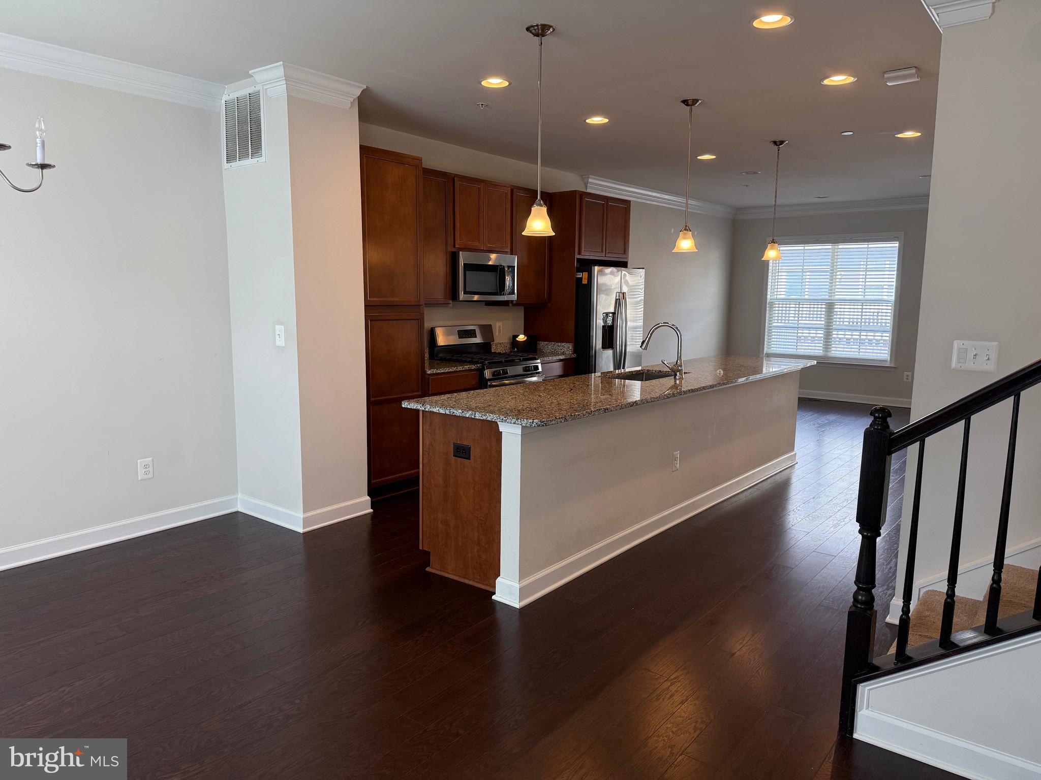 3038 Mia Lane Upper Marlboro, MD 20774 - Photo 3 of 6 a large kitchen with stainless steel appliances a large counter top and a wooden floor