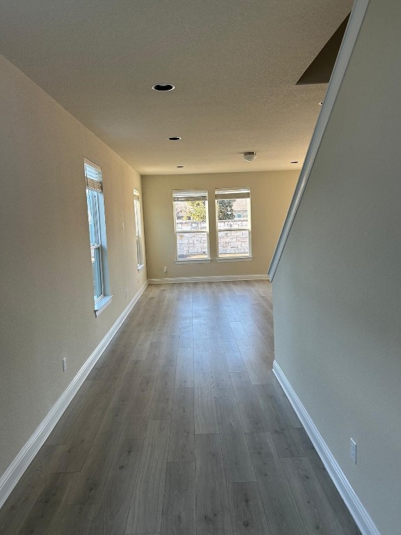 108 Landry Street Georgetown, TX 78628 - Photo 3 of 14 wooden floor in an empty room with a window