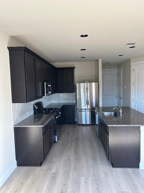 108 Landry Street Georgetown, TX 78628 - Photo 4 of 14 a kitchen with stainless steel appliances granite countertop a sink a stove and a refrigerator