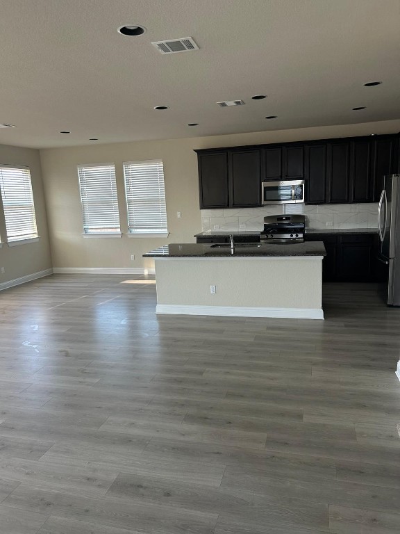 108 Landry Street Georgetown, TX 78628 - Photo 5 of 14 a view of kitchen with stainless steel appliances wooden floor and window