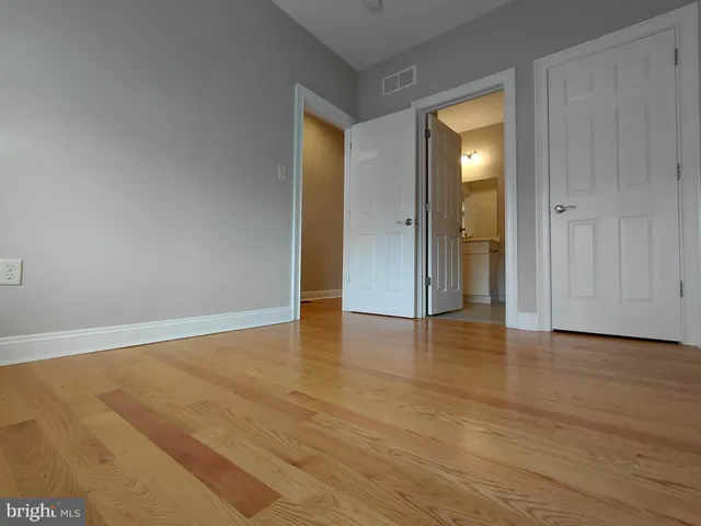 a view of an empty room and wooden floor