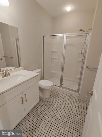 a view of empty room with wooden floor and sink