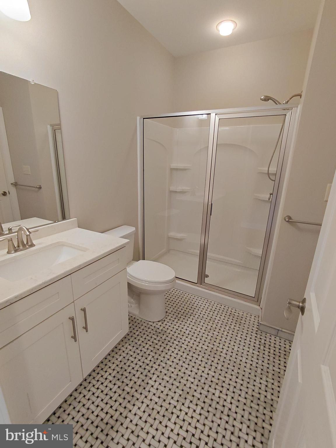 912 Cemetery Road Quakertown, PA 18951 - Photo 11 of 16 a bathroom with a sink a toilet a mirror and shower