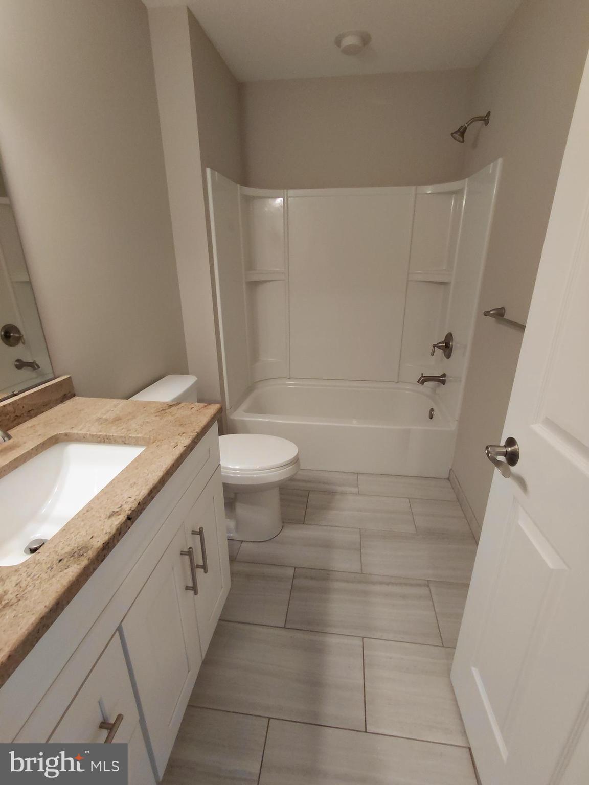 912 Cemetery Road Quakertown, PA 18951 - Photo 12 of 16 a bathroom with a granite countertop sink toilet and shower