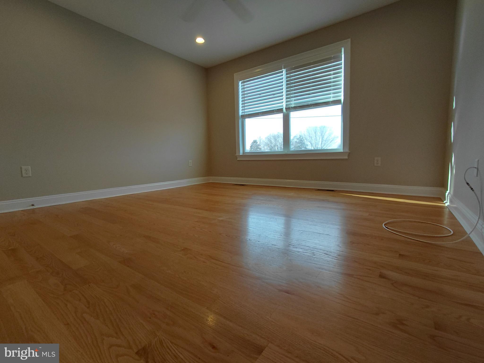 912 Cemetery Road Quakertown, PA 18951 - Photo 4 of 16 a view of an empty room with wooden floor and a window
