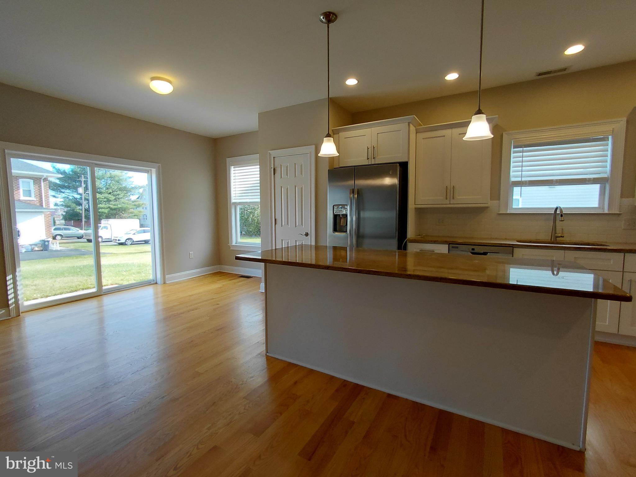 912 Cemetery Road Quakertown, PA 18951 - Photo 5 of 16 a large kitchen with stainless steel appliances a large counter top a wooden floors and a large window