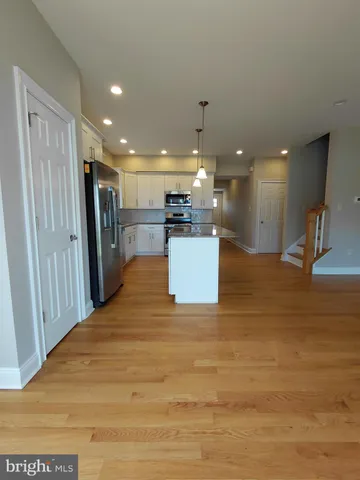 a view of a kitchen with a sink and a stove top oven