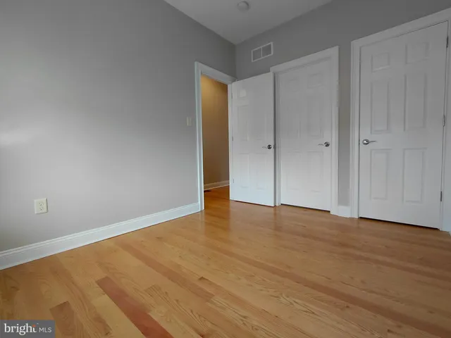 a kitchen with stainless steel appliances granite countertop a sink a stove a refrigerator and a sink with wooden floor