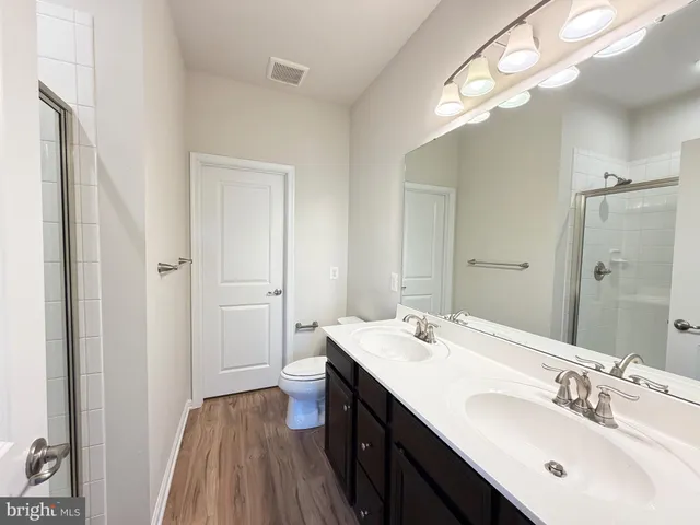 a bathroom with a sink a mirror and a shower
