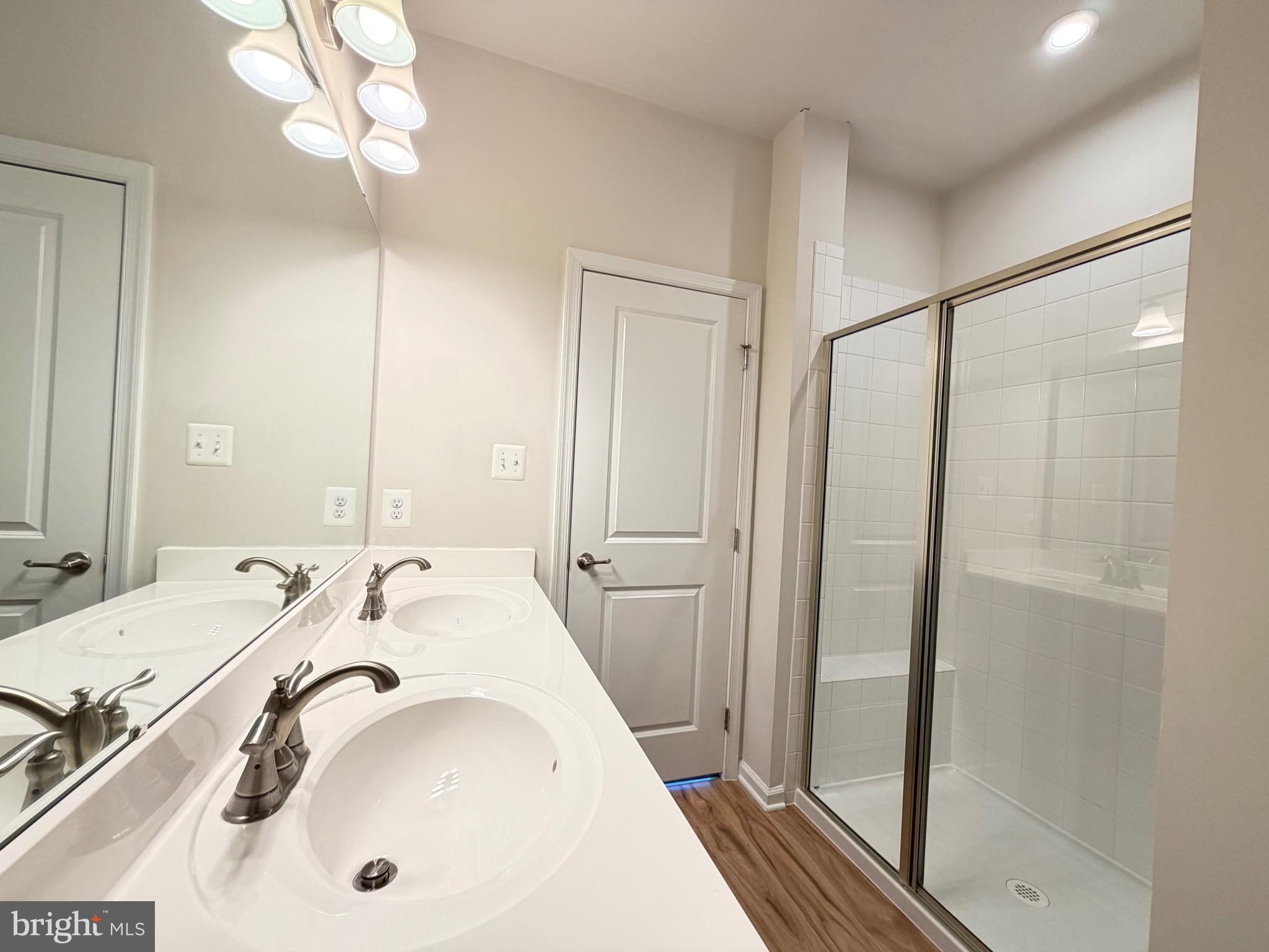 1325 Bruley Road Hanover, MD 21076 - Photo 13 of 22 a bathroom with a tub a sink and a mirror