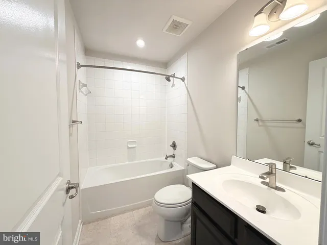 a bathroom with a sink toilet tub and shower