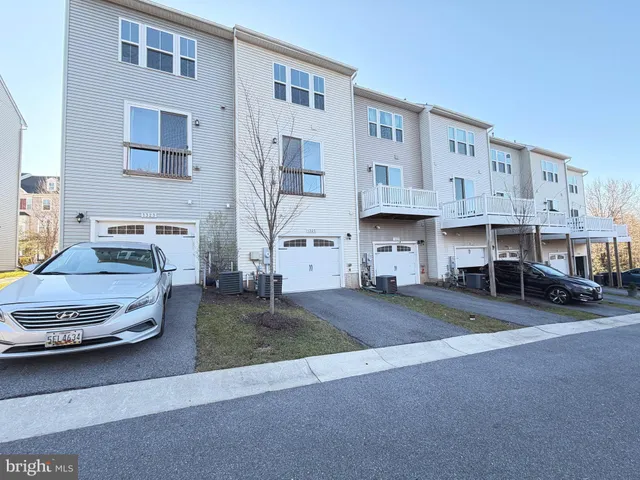a view of a street that has couple of cars parked in front of it