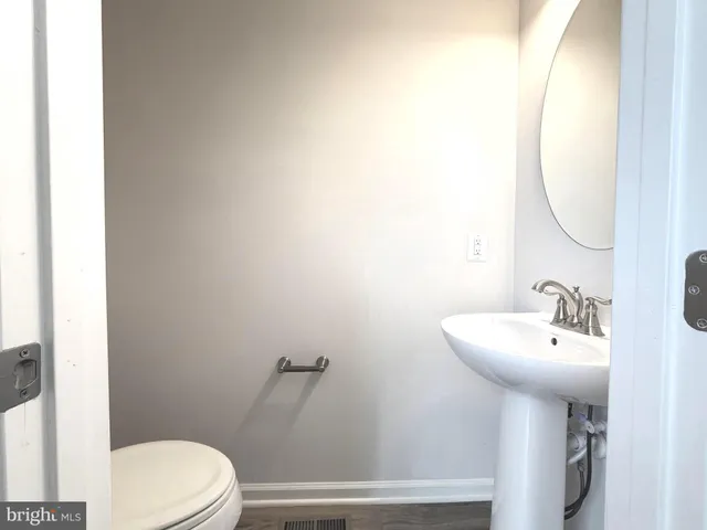 a bathroom with a sink mirror and toilet