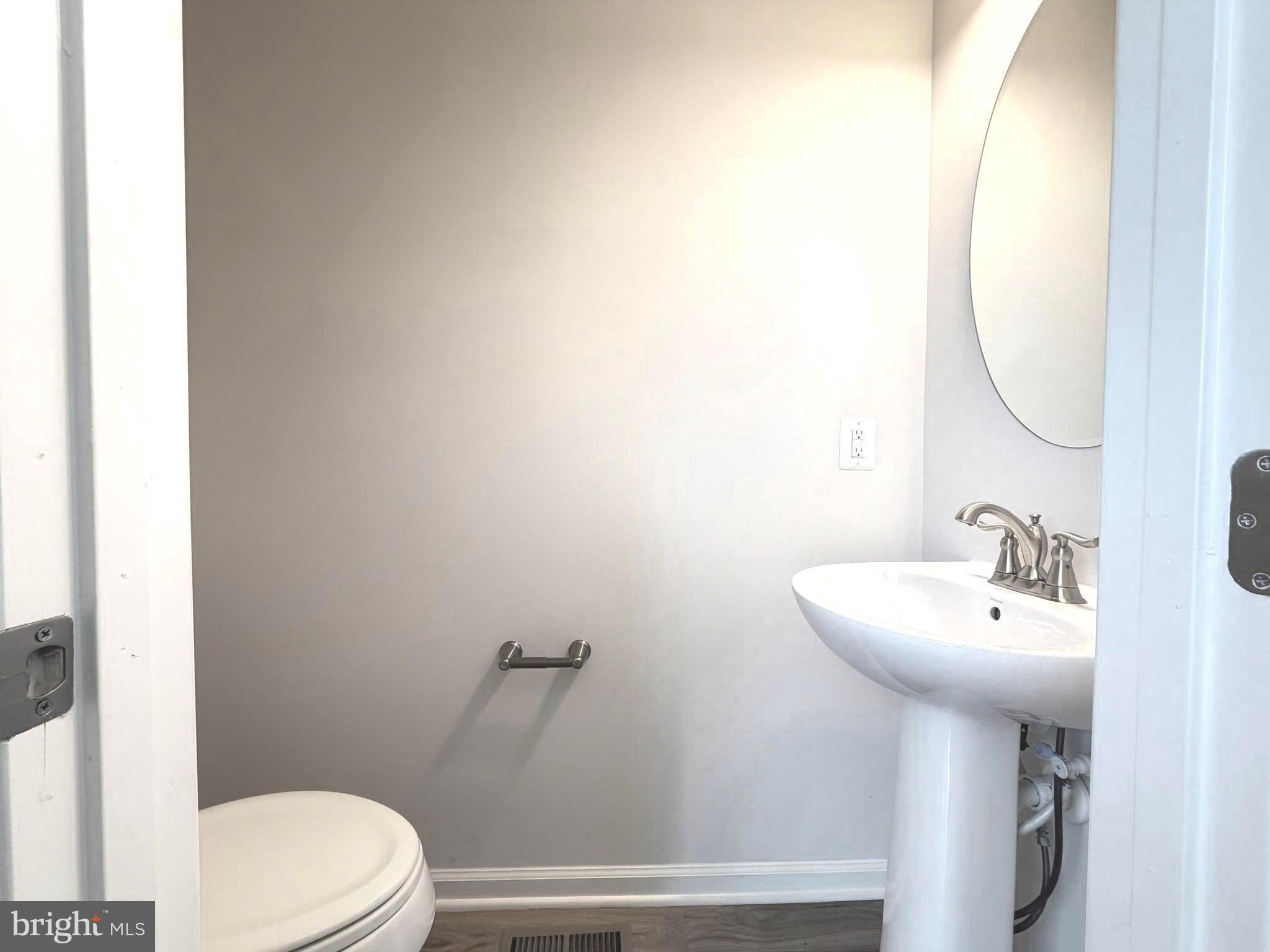 1325 Bruley Road Hanover, MD 21076 - Photo 9 of 22 a bathroom with a sink mirror and toilet