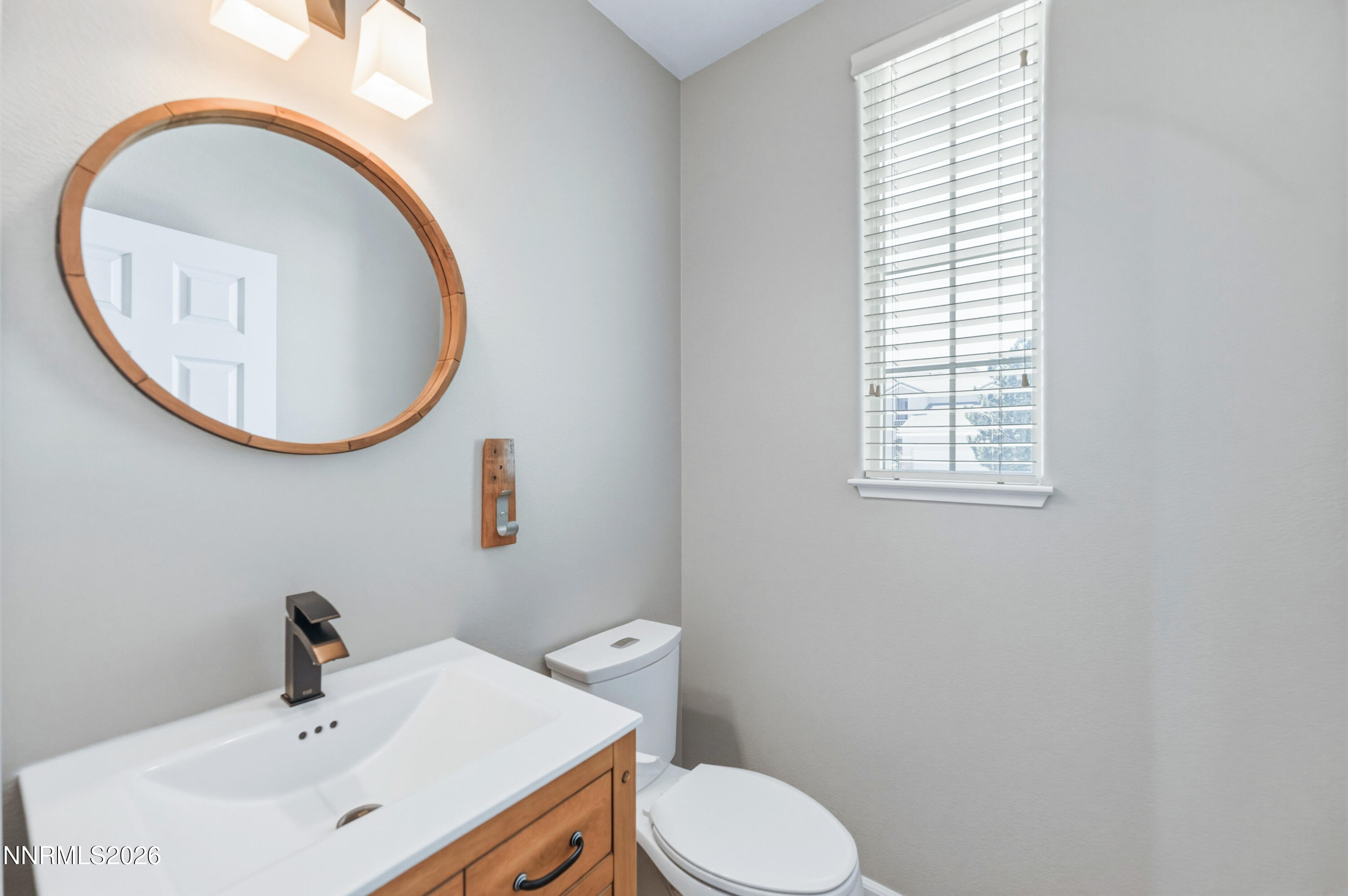 1770 Kodiak Circle Reno, NV 89511 - Photo 25 of 32 a bathroom with a sink a mirror and a toilet