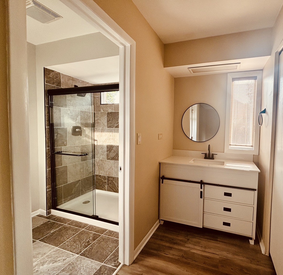325 Shadow Bend Drive Wheeling, IL 60090 - Photo 15 of 26 a bathroom with a sink a mirror and a shower