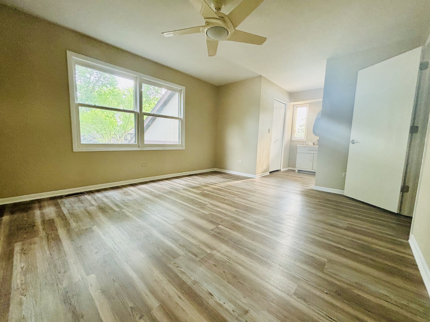 325 Shadow Bend Drive Wheeling, IL 60090 - Photo 19 of 26 a view of an empty room with wooden floor and a window