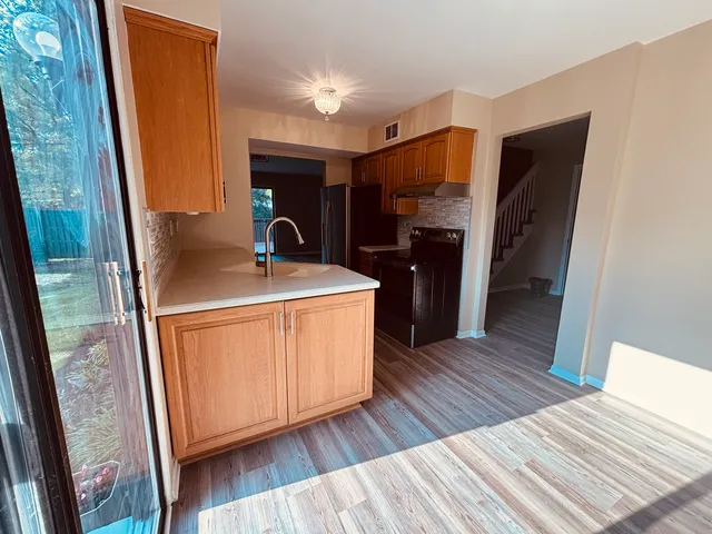 a room with wooden floor and furniture