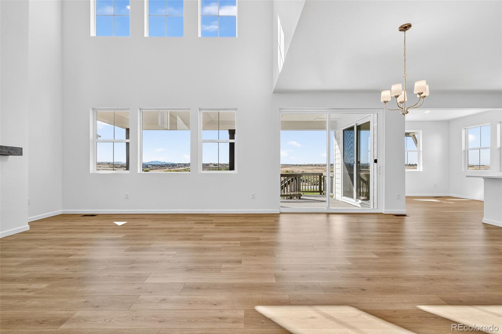 4297 Ridgewalk Point Castle Rock, CO 80108 - Photo 11 of 50 a view of an empty room with wooden floor and a window