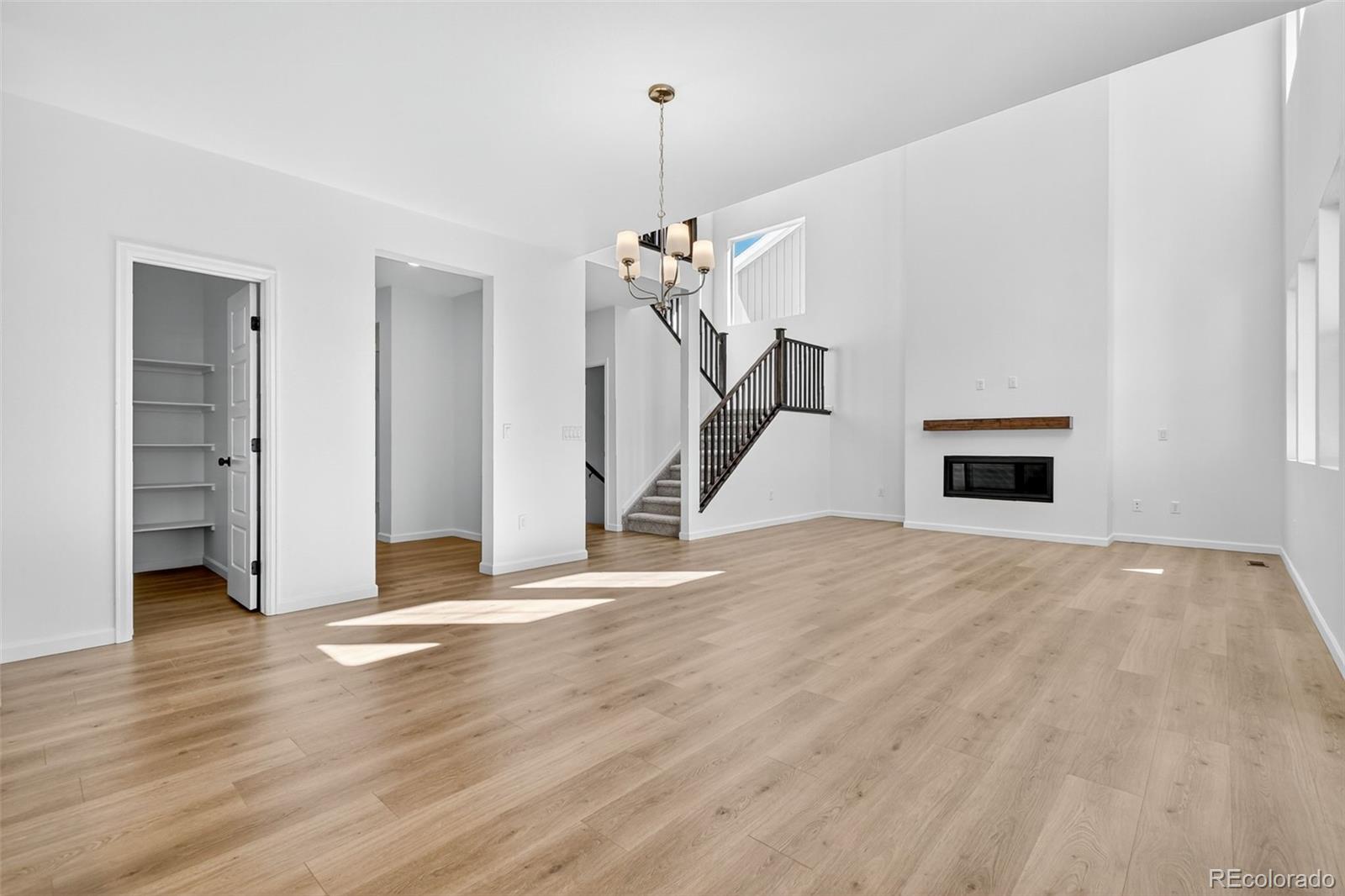 4297 Ridgewalk Point Castle Rock, CO 80108 - Photo 13 of 50 a view of a room with wooden floor staircase and a ceiling fan