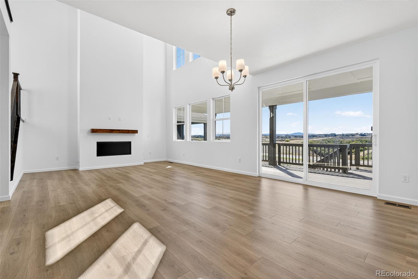 4297 Ridgewalk Point Castle Rock, CO 80108 - Photo 14 of 50 a view of an empty room with wooden floor and a window